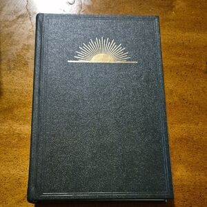 Black Hardcover Book with Gold Sunburst Design